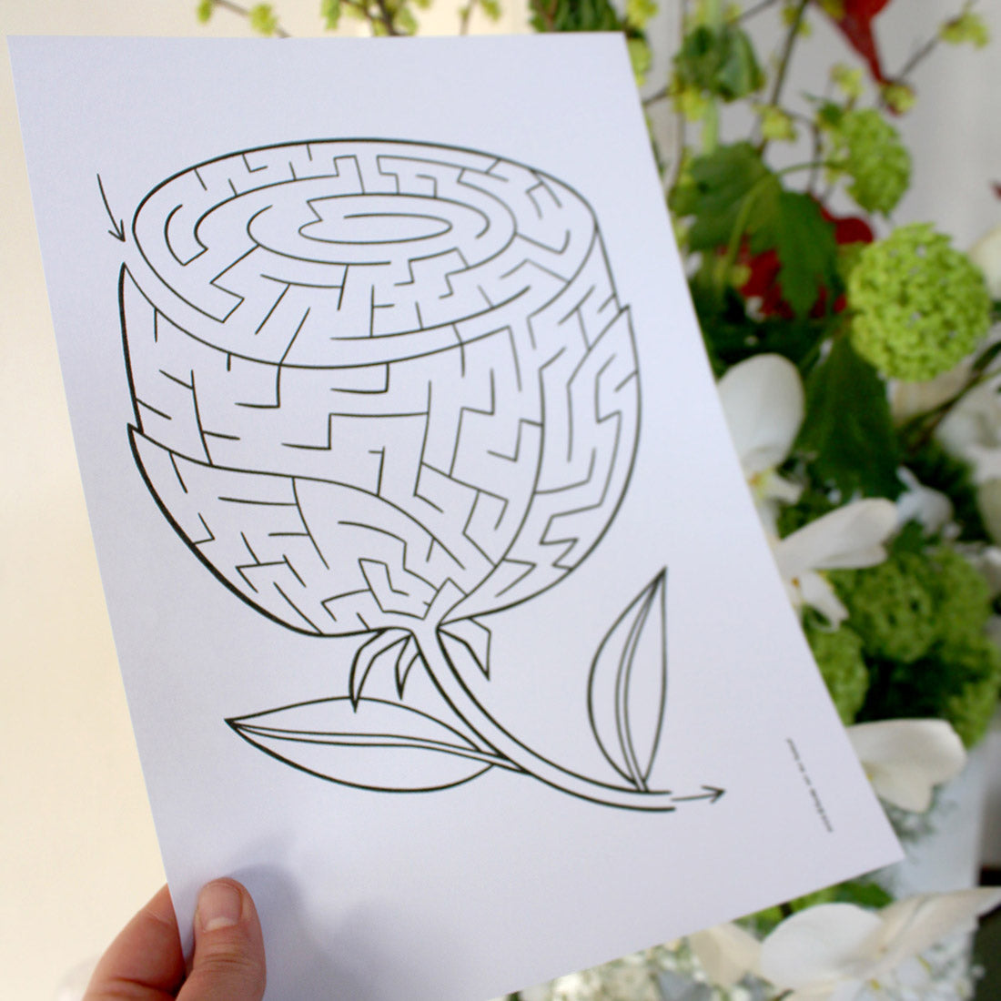 Printable maze puzzle of a rose, part of wedding themed bundle, in front of floral background.